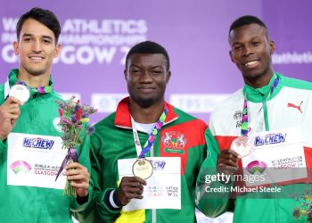GLASGOW, SCOTLAND - MARCH 03:  Silver medallist Yasser Mohammed Triki of Team Algeria, gold medallist Hugues Fabrice Zango of Team Burkina Faso and bronze medallist Tiago Pereira of Team Portugal pose for a photo during the medal ceremony for the Men's Triple Jump Final on Day Three of the World Athletics Indoor Championships Glasgow 2024 at Emirates Arena on March 03, 2024 in Glasgow, Scotland. (Photo by Michael Steele/Getty Images)