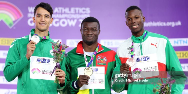 GLASGOW, SCOTLAND - MARCH 03:  Silver medallist Yasser Mohammed Triki of Team Algeria, gold medallist Hugues Fabrice Zango of Team Burkina Faso and bronze medallist Tiago Pereira of Team Portugal pose for a photo during the medal ceremony for the Men's Triple Jump Final on Day Three of the World Athletics Indoor Championships Glasgow 2024 at Emirates Arena on March 03, 2024 in Glasgow, Scotland. (Photo by Michael Steele/Getty Images)
