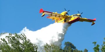 Ascoli Piceno, Italy - July 21, 2006: Canadair in action on the hills of the Marche, in Italy, while extinguishing a fire in a forest. The canadair is a propeller plane and is able to take a great quantity of water from the sea or even from a lake and to throw on the fire with precision